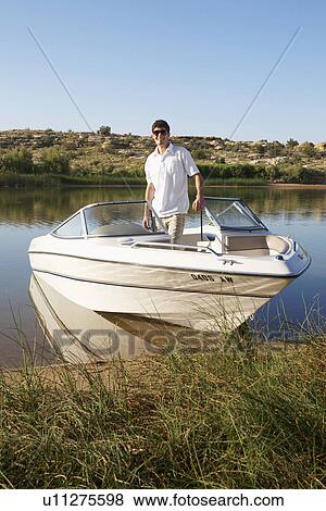 Young man in motorboat View Large Photo Image Stock Photo - Young man in motorboat. Fotosearch