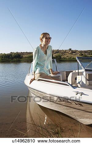 Young woman in motorboat View Large Photo Image Stock Image - Young woman in motorboat. Fotosearch