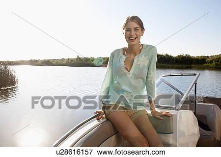Young woman in motorboat View Large Photo Image Stock Photo - Young woman in motorboat. Fotosearch