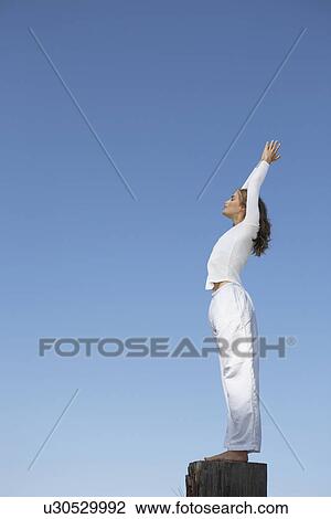 Young woman practicing yoga on tree stump View Large Photo Image Stock Image - Young woman practicing yoga on tree stump. Fotosearch