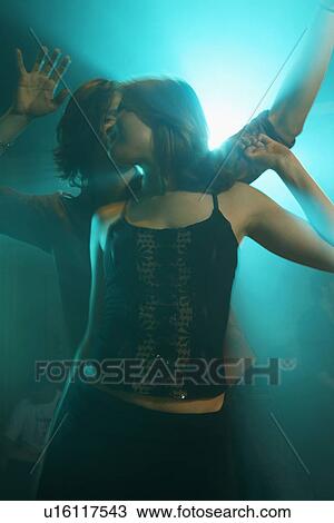 Two young people clubbing (back lighting) View Large Photo Image Stock Image - Two young people clubbing (back lighting). Fotosearch
