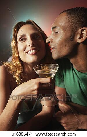 Young couple flirting at nightclub View Large Photo Image Stock Image - Young couple flirting at nightclub. Fotosearch