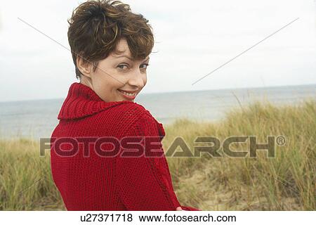 Woman in cardigan at beach (portrait) View Large Photo Image Stock Photo - Woman in cardigan at beach (portrait). Fotosearch