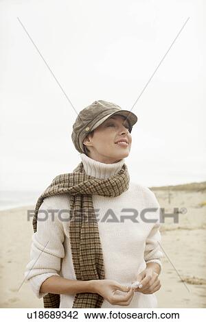 Woman in turtleneck sweater standing on beach View Large Photo Image Stock Image - Woman in turtleneck sweater standing on beach. Fotosearch