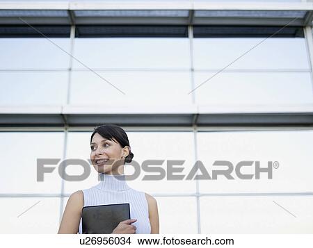 Businesswoman holding file View Large Photo Image Picture - Businesswoman holding file. Fotosearch