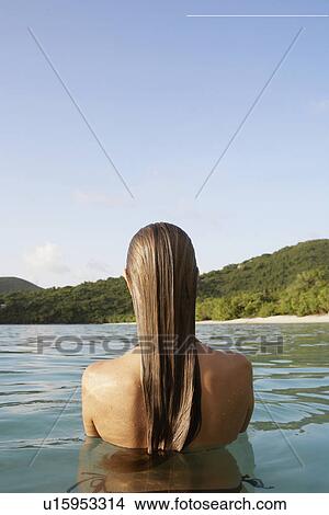 Mid adult woman standing in ocean (rear view), St. John, US Virgin Islands, USA View Large Photo Image Picture - Mid adult woman standing in ocean (rear view), St. John, US Virgin Islands, USA. Fotosearch