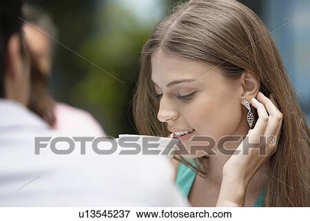 Woman drinking tea near man View Large Photo Image Stock Photo - Woman drinking tea near man. Fotosearch