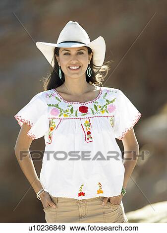Stock Photo - Woman wearing cowboy hat, portrait. Fotosearch
