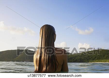 Woman with wet long hair standing in ocean (rear view), St. John, US Virgin Islands, USA View Large Photo Image Stock Photo - Woman with wet long hair standing in ocean (rear view), St. John, US Virgin Islands, USA. Fotosearch