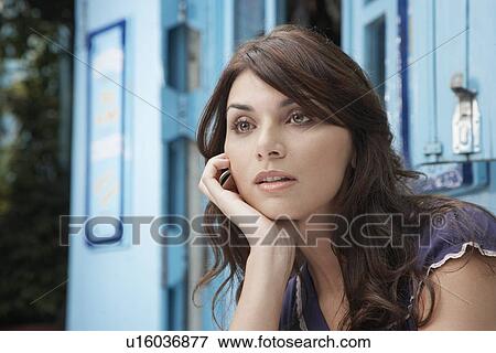 Young woman day dreaming with chin on hand (portrait) View Large Photo Image Stock Photo - Young woman day dreaming with chin on hand (portrait). Fotosearch