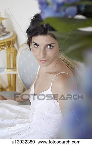 Stock Image - Young woman in dress (portrait, high angle view). Fotosearch