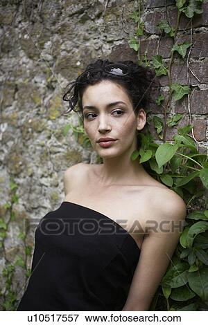 Young woman leaning on wall View Large Photo Image Stock Photo - Young woman leaning on wall. Fotosearch