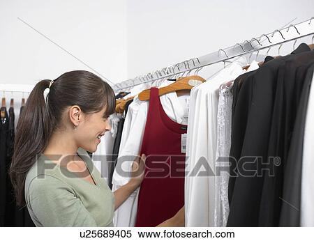 Stock Photography - Young woman shopping clothes. Fotosearch