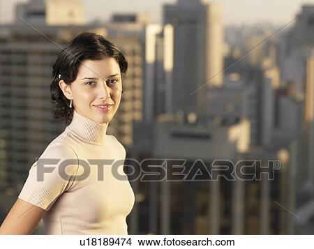 Young woman, skyscrapers in background (portrait), Sao Paolo, Brazil View Large Photo Image Picture - Young woman, skyscrapers in background (portrait), Sao Paolo, Brazil. Fotosearch