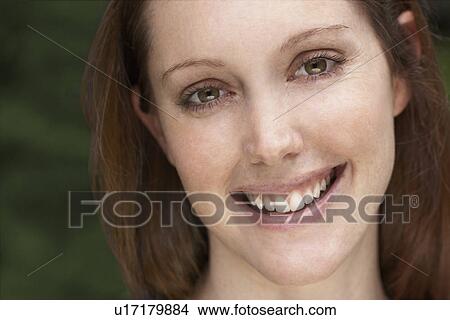 Young woman smiling (portrait) View Large Photo Image Picture - Young woman smiling (portrait). Fotosearch