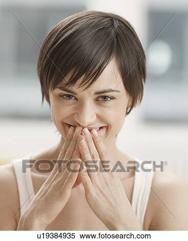 Stock Photography - Young Woman with Hands on Mouth. Fotosearch