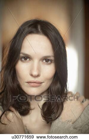 Young woman with hands on shoulders (portrait) View Large Photo Image Stock Photo - Young woman with hands on shoulders (portrait). Fotosearch