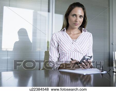 Stock Photo - Businesswoman using cell phone (portrait). Fotosearch