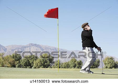 Man on cell phone at golf course View Large Photo Image Stock Image - Man on cell phone at golf course. Fotosearch
