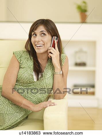 Stock Image - Mid-Adult on Cell Phone. Fotosearch