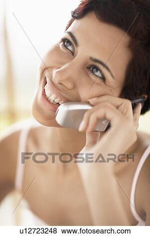 Mid adult woman talking on cell phone View Large Photo Image Stock Photo - Mid adult woman talking on cell phone. Fotosearch