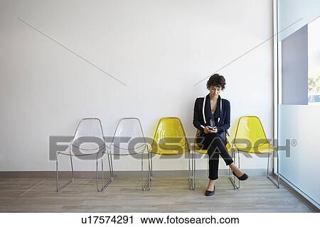 Teenage girl using cell phone in lobby View Large Photo Image Stock Image - Teenage girl using cell phone in lobby. Fotosearch