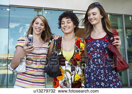 Teenage girls photographing themselves with cell phone View Large Photo Image Stock Image - Teenage girls photographing themselves with cell phone. Fotosearch