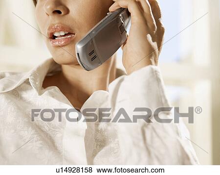 Young woman on cell phone (close-up) View Large Photo Image Stock Photo - Young woman on cell phone (close-up). Fotosearch
