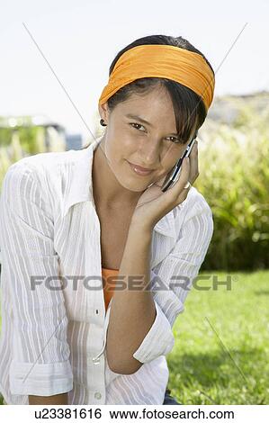 Young woman on cell phone View Large Photo Image Stock Photograph - Young woman on cell phone. Fotosearch