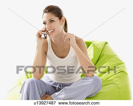 Young woman talking on cell phone View Large Photo Image Stock Photo - Young woman talking on cell phone. Fotosearch