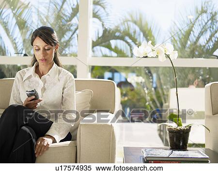 Young woman using cell phone View Large Photo Image Stock Photography - Young woman using cell phone. Fotosearch