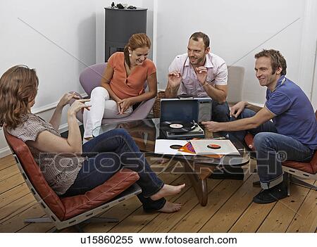 Four friends listening to vinyl records View Large Photo Image Stock Photography - Four friends listening to vinyl records. Fotosearch