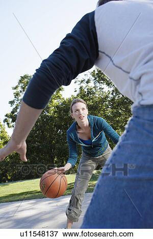 Man and woman playing basketball View Large Photo Image Stock Photo - Man and woman playing basketball. Fotosearch