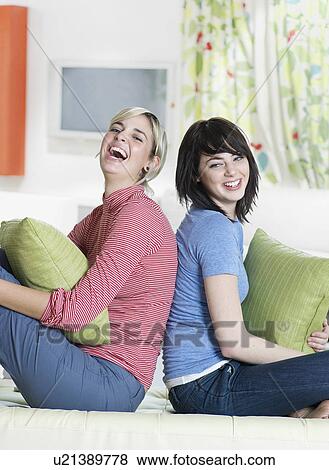 Two Young Women Sitting Back to Back View Large Photo Image Stock Photo - Two Young Women Sitting Back to Back. Fotosearch