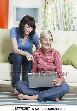 Stock Photo - Two Young Women Using Laptop. Fotosearch