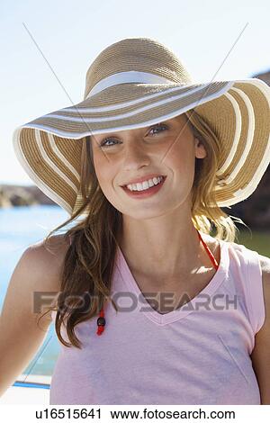 Portrait of young woman in sun hat View Large Photo Image Stock Image - Portrait of young woman in sun hat. Fotosearch