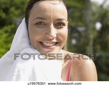 Stock Image - Woman drying herself with towel (portrait). Fotosearch