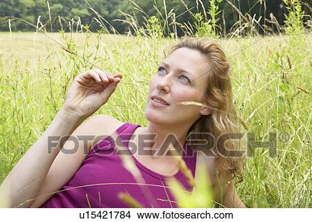 Woman lying on grass View Large Photo Image Picture - Woman lying on grass. Fotosearch
