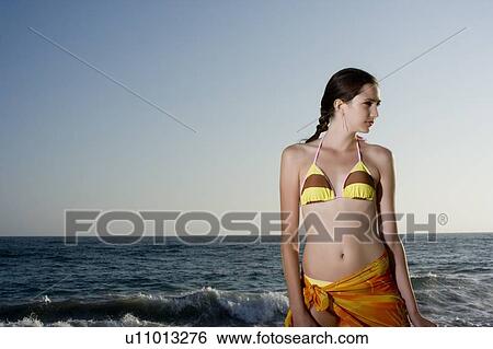 Young adult woman in bikini looking sideways, Front View, Copy Space, Side View View Large Photo Image Stock Photograph - Young adult woman in bikini looking sideways, Front View, Copy Space, Side View. Fotosearch