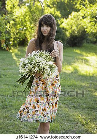 Young Woman Holding Bunch of Flowers View Large Photo Image Picture - Young Woman Holding Bunch of Flowers. Fotosearch