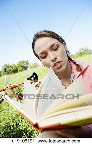 Young woman reading book in park View Large Photo Image Stock Image - Young woman reading book in park. Fotosearch