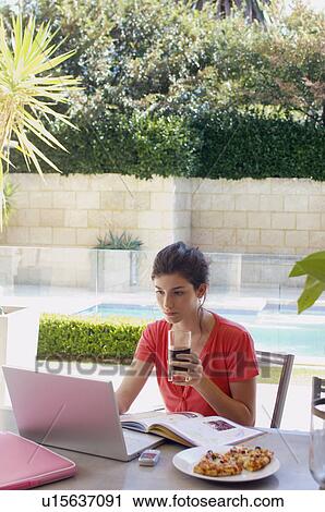 Young woman studying and having snack in garden View Large Photo Image Stock Image - Young woman studying and having snack in garden. Fotosearch