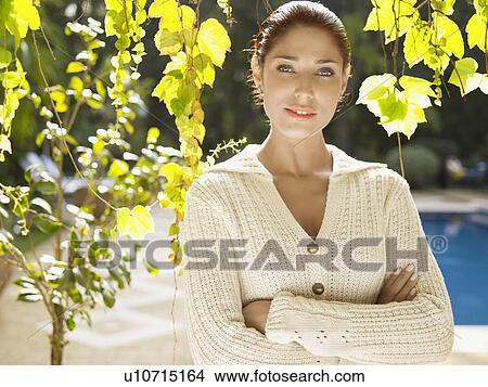 Picture - Young woman under tree (portrait). Fotosearch