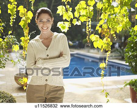 Young woman under tree (portrait) View Large Photo Image Stock Image - Young woman under tree (portrait). Fotosearch