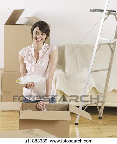 Young Woman Packing Cardboard Boxes View Large Photo Image Stock Photo - Young Woman Packing Cardboard Boxes. Fotosearch