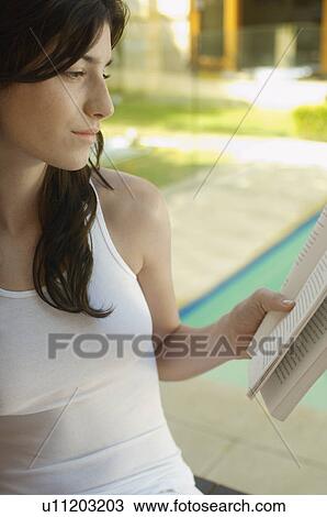 Young woman reading book by swimming pool View Large Photo Image Stock Image - Young woman reading book by swimming pool. Fotosearch