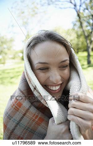 Young woman wrapped in a blanket View Large Photo Image Stock Photo - Young woman wrapped in a blanket. Fotosearch