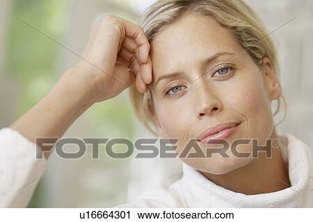 Stock Image - Mid adult woman with blond hair (portrait). Fotosearch