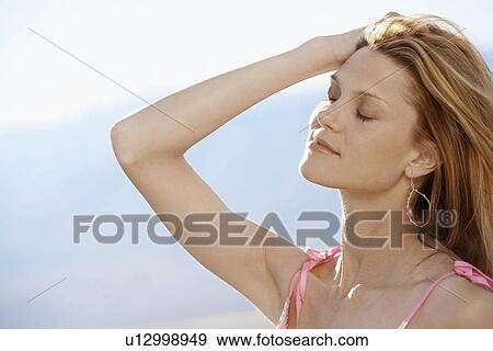 Mid adult woman with hand on head View Large Photo Image Stock Photo - Mid adult woman with hand on head. Fotosearch