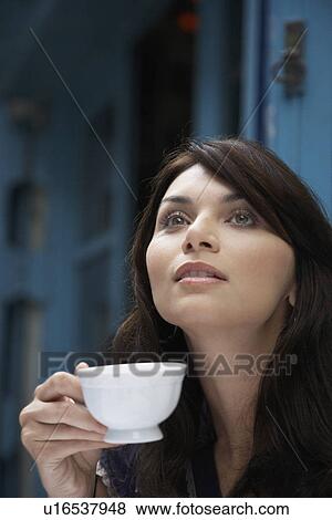 Young woman drinking coffee View Large Photo Image Stock Photo - Young woman drinking coffee. Fotosearch